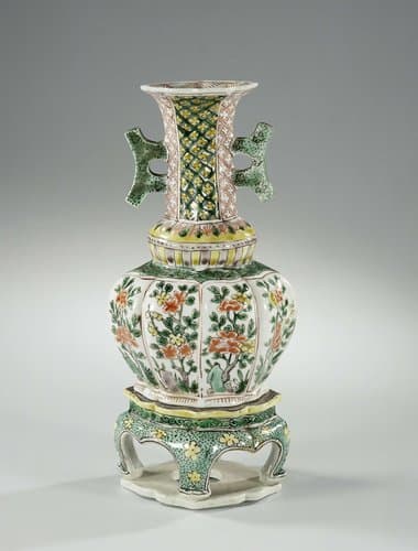 Octagonal vase with two handles, flowering plants and diaper pattern on a seperate stand by anonymous