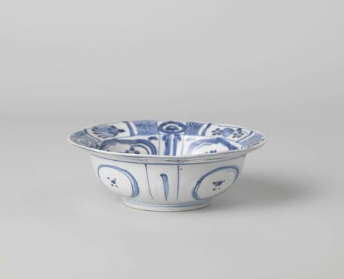 Klapmuts bowl with a bird on a rock near flowering plants by anonymous