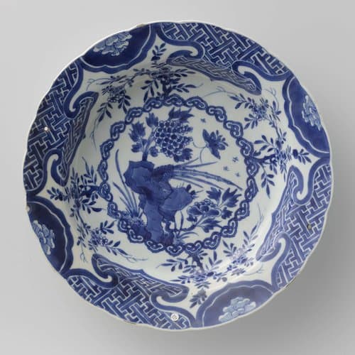 Dish with a pheasant on a rock, butterfly and flower sprays by anonymous