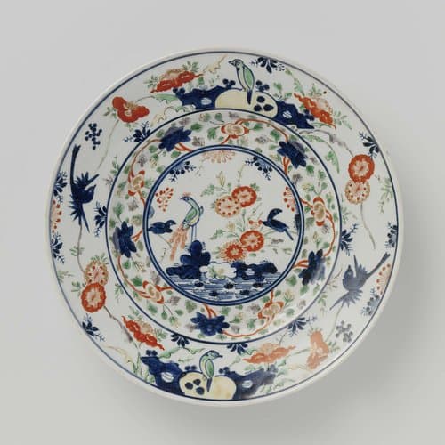 Plate with birds on rocks and near flowering plants by anonymous