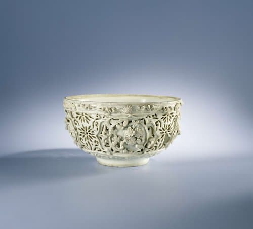 Bowl with pierced sides and moulded flower sprays and floral scrolls by anonymous