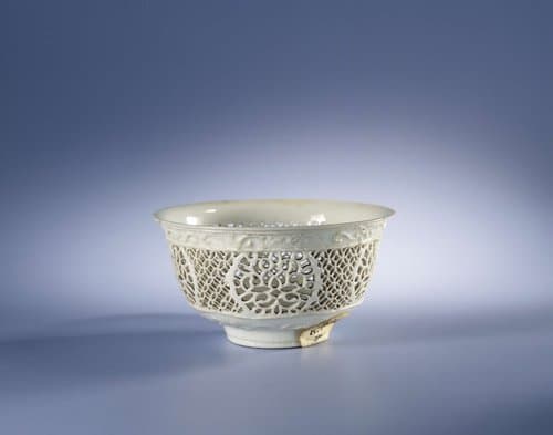 White bowl with pierced sides and flower sprays in relief by anonymous