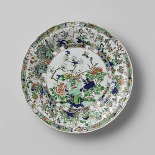 Dish with a pheasant on a rock surrounded by flowering plants by anonymous