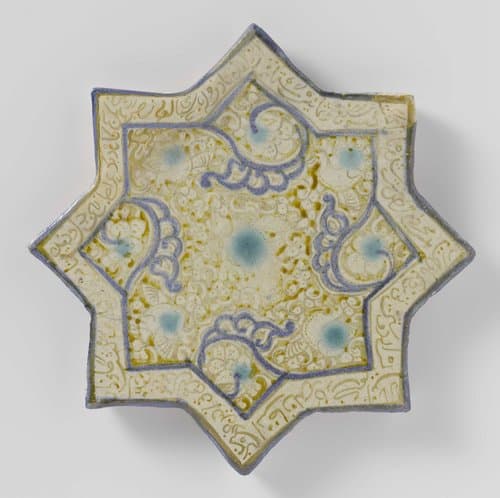 Star-shaped tile with an inscription and floral scrolls by anonymous