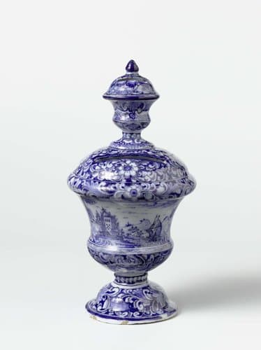 Spaarpot op voet, in blauw beschilderd met landschappen tussen bloemornament by anonymous
