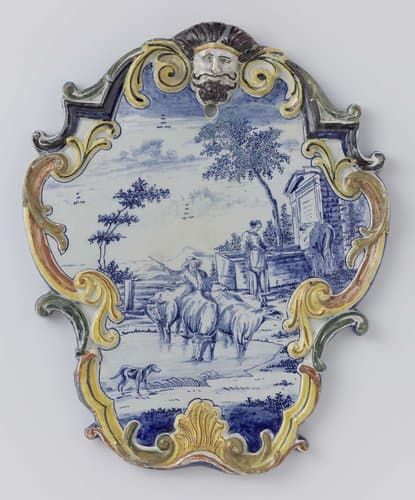 Plaat in de vorm van een cartouche met mascaron; beschilderde in blauw met een landschap met koeien by anonymous