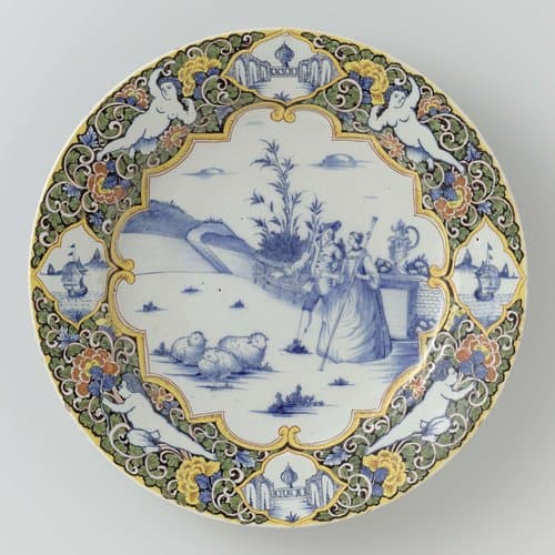 Schotel met op het plat in blauw een herdersscène binnen Louis XIV rand. Veelkleurige randversiering op zwarte grond met putti en vier medaillons by anonymous