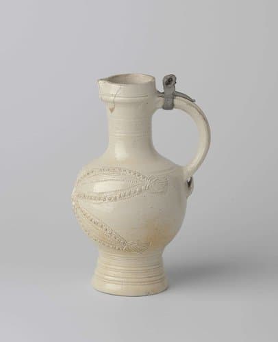 Jug with a mask and stylized leaves by anonymous