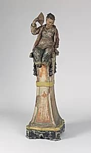 Figure on pedestal by Unknown